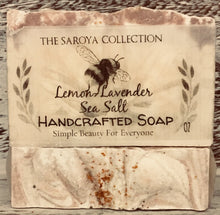 Load image into Gallery viewer, Lemon-Lavender Sea Salt Soap - The Saroya Collection-has calming effects  on the skin, body &amp; mind. 100% natural &amp; topped with a touch of lavender buds. It smells like walking through the lavender fields of Provence, soothing &amp; so intoxicating to the senses. This soap is naturally scented with lemon + lavender essential oil. 